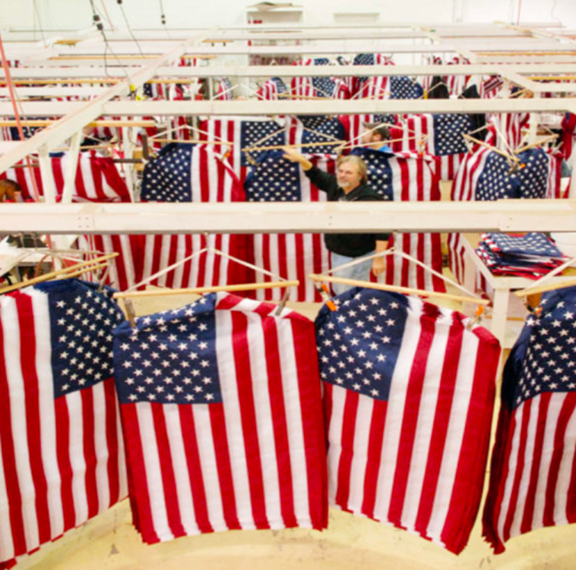 Workers at the Annin flag factory assembling rows of American flags